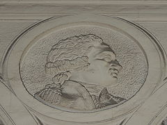 Bas-relief, la tête d'un homme de profil.