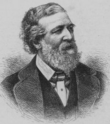 Portrait d'un homme entre deux âges, les cheveux bruns et la barbe grisonnante. Il porte un costume classique de la fin du XIXe siècle.