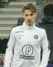 Bust of Anthony Rouault, dressed in Toulouse White training shirt