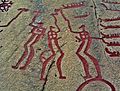 Nordijski bronastodobni petroglif s postavami, ki držijo kladiva ali sekiram podobne predmete med tanumskimi vklesanimi skalami, Švedska