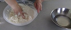 Mixing flour, water and a pinch of salt to make dough
