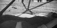 Regolith beneath NASA's Phoenix Mars Lander, where the descent thrusters have apparently cleared away several patches of dust to expose the underlying ice.