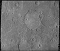 The Schubert basin, 190 km (120 mi) in diameter, filled by smooth plains. The basin's hummocky rim is partly degraded and cratered by later events.