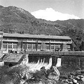 Black-and-white photo of the exterior of a hydroelectric plant