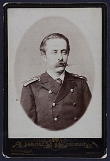 Sepia portrait photograph of Pavel Novitsky with "cabinet portrait" written at the bottom of the image