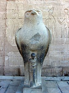 Horus statue with a smaller statue of Caesarion at temple of Edfu, Upper Egypt[15]