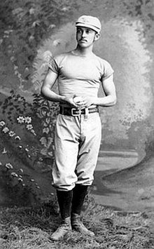 Richmond standing, holding a baseball