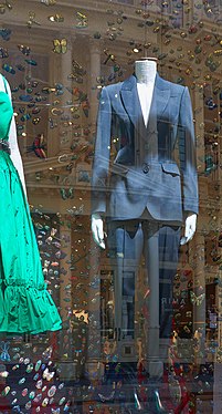 Current Fashion by McQueen on 71 Greene Street with pillars of cast iron building reflected in the background.