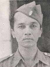 A man in a military uniform, looking forward