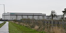 A selection of grey buildings at least two-storeys high, with Siemens branding on the left hand side