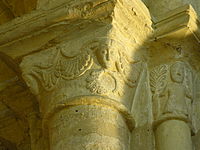 Capital showing human faces and ferns