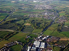 The A80 (r) and M80 (l) from the air. Garnkirk Burn is shown by the line of trees at the bottom left. The fireclay works is now a scrapyard beyond the bottom right on the railway line. Garnkirk House is now the clubhouse at Crow Wood Golf Club.