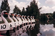 Photographie d'un bassin avec des petits bateaux en forme de cygne.