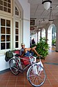 ☎∈ A trishaw and rider at the Raffles Hotel arcade.