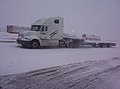 Freightliner Columbia with single drop flatbed (also known as a stepdeck) trailer