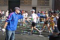 A volunteer hands out Gatorade on Beacon Street.