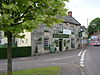 Stone building with sign saying The Old Pound Inn, on street junction.