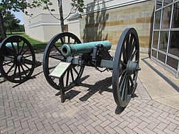 Photo shows a wheeled artillery piece labeled "12-Pounder Rifled James".