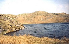 A deep blue lake surrounded by steep sides