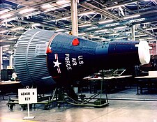 A spacecraft in a museum, displaying a United States Air Force color scheme