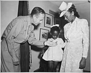 Melba Rose, aged 2, daughter of Mrs. Rosie L. Madison viewing the Silver Star posthumously awarded her father 1st Lt. John W. Madison, of the 92nd Infantry Division, who was killed in action in Italy with Bri. Gen. Robert N. Young