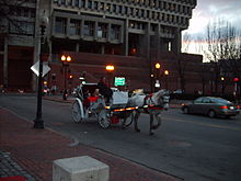 Horse-drawn carriage at dusk on a city street