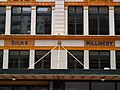 Signs on the side of the building now known as the Downing Centre