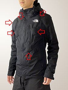 The first stunt jacket with 6x bullet hit squibs (labelled) embedded. Each squib contains 25 g of fake blood with a modest bulge on a dark fabric.