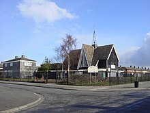 Roadside church with a black iron fence