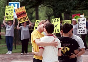 Lesbian and gay students kissing in front of anti-LGBT protesters (10 May 2000)