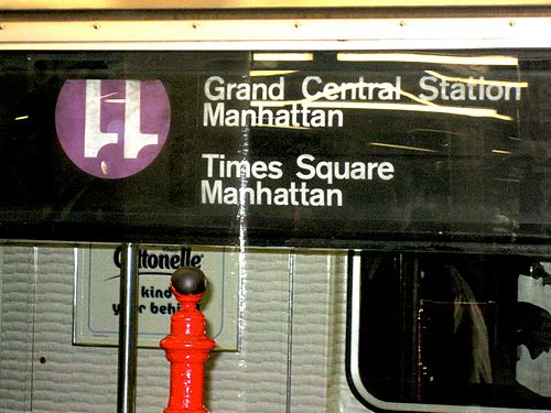 An R62A-class car operating on the 42nd Street Shuttle erroneously shows an upside down 11 sign instead of the usual gray-backgrounded S for shuttles. The purple color currently corresponds to the IRT Flushing Line.