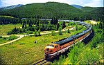 Postcard photo of the California Zephyr in the Colorado Rockies in the mid-20th century. The train is being pulled by Denver and Rio Grande locomotives for this stretch of its trip.