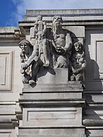 Stone sculpture of a seated man holding a lyre, between two kneeling figures