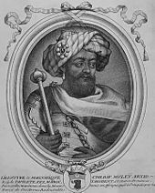 portrait en noir et blanc d'un homme portant barbe et turban tenant un sceptre.