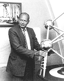 André Waterkeyn, the engineer of the Atomium, in front of a model of his creation