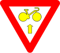 B23: Bike may pass a yellow or red light to go straight, after yield