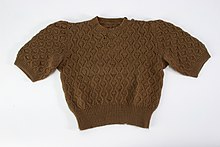 Photo of a brown shirt knit with patterns on it