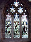 Aidan avbilda til venstre på eit glasmåleri i All Saints-kyrkja i York.