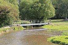 Narrow river between two fields