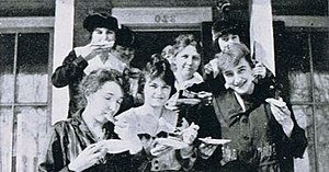 Sturgeon Bay High School (7–12) students eating, from the 1916–1917 school year, caption reads "Just lunching"