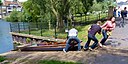 ☎∈ A punt being pulled up rollers on the slipway between the upper and lower levels of the River Cam near the Mill Pool in Cambridge, England.