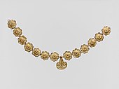 Necklace; 1400-1050 BC; gilded terracotta; diameter of the rosettes: 2.7 cm, with variations of circa 0.1 cm, length of the pendant 3.7 cm; Metropolitan Museum of Art