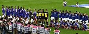 A group of people standing alongside each other in a row