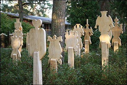 Restored Kursenieki wooden grave markers (krikštai) at Nida cemetery