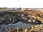 Converting the area for residential use required cleaning the soil, revealing the old coastal cliffs.