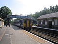 A Northern Rail Class 156 waits at the station.