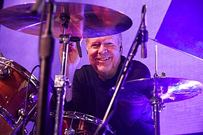 John "JR" Robinson looks at the viewer through parts of his drumkit. Photograph by Suzanne Teresa in 2017.