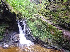 Steps beside a large waterfall.