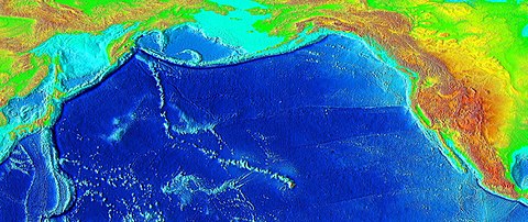 Raised-relief map of the Pacific basin, showing seamounts and islands trailing the Hawaiʻi hotspot in a long line terminating near the Russian island of Kamchatka Peninsula in Russia.