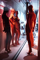 red zentai wearing mannequins in a shop display